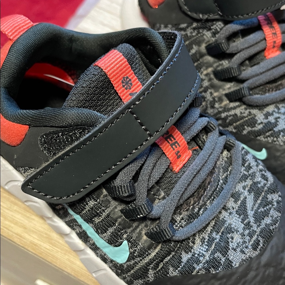 Nike Kids Black and White Sneakers with Orange Accents. - Picture 6 of 6